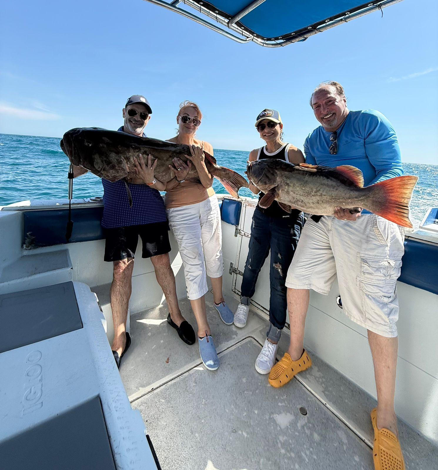 Guests displaying catches from a 6-hour Rocky Point fishing charter 1